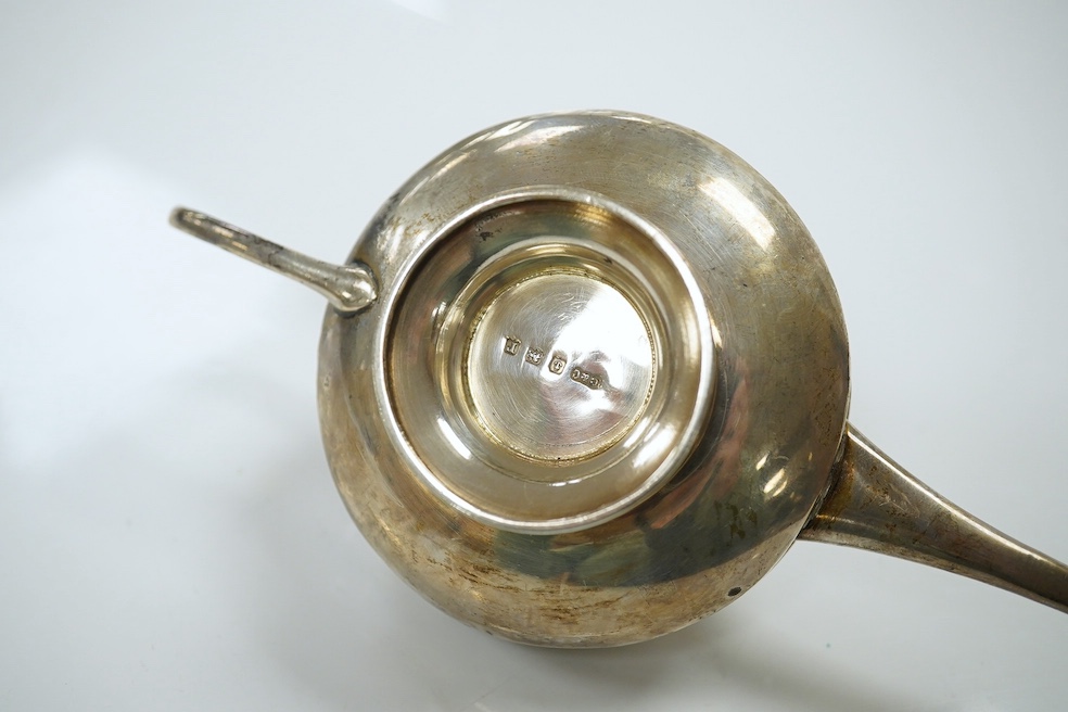 A group of assorted small silver comprising a George III helmet cream jug, a George V oil lamp cigar lighter, two stamp cases (6.5 oz), a white metal bowl stamped silver, an Indian white metal measuring cup, a small brus